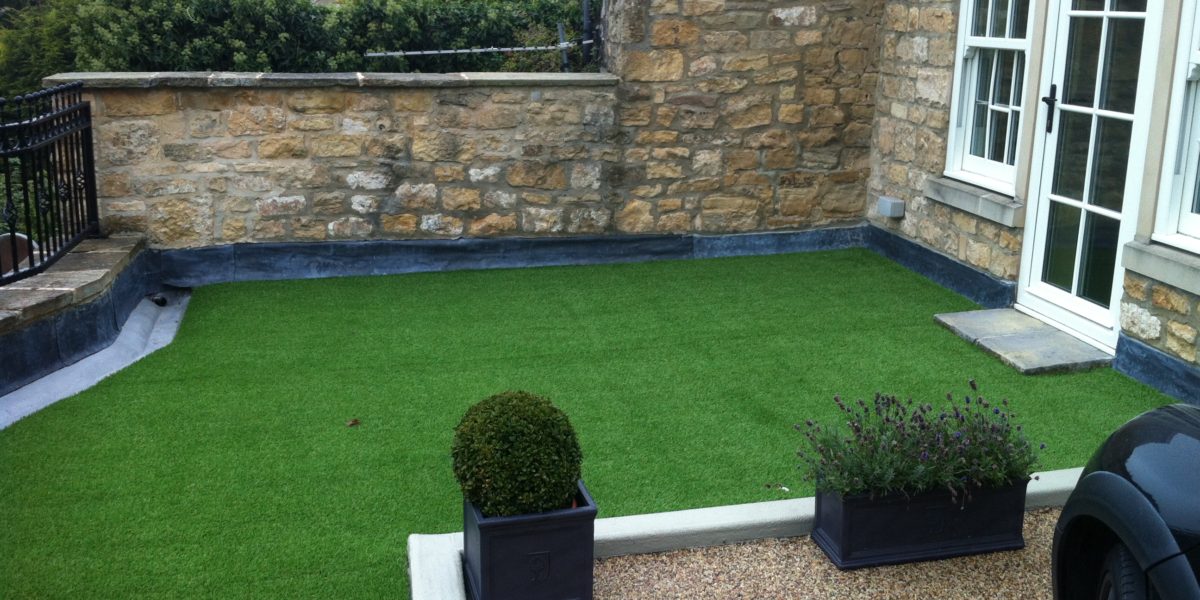 Garden and drive over a podium deck with basement below